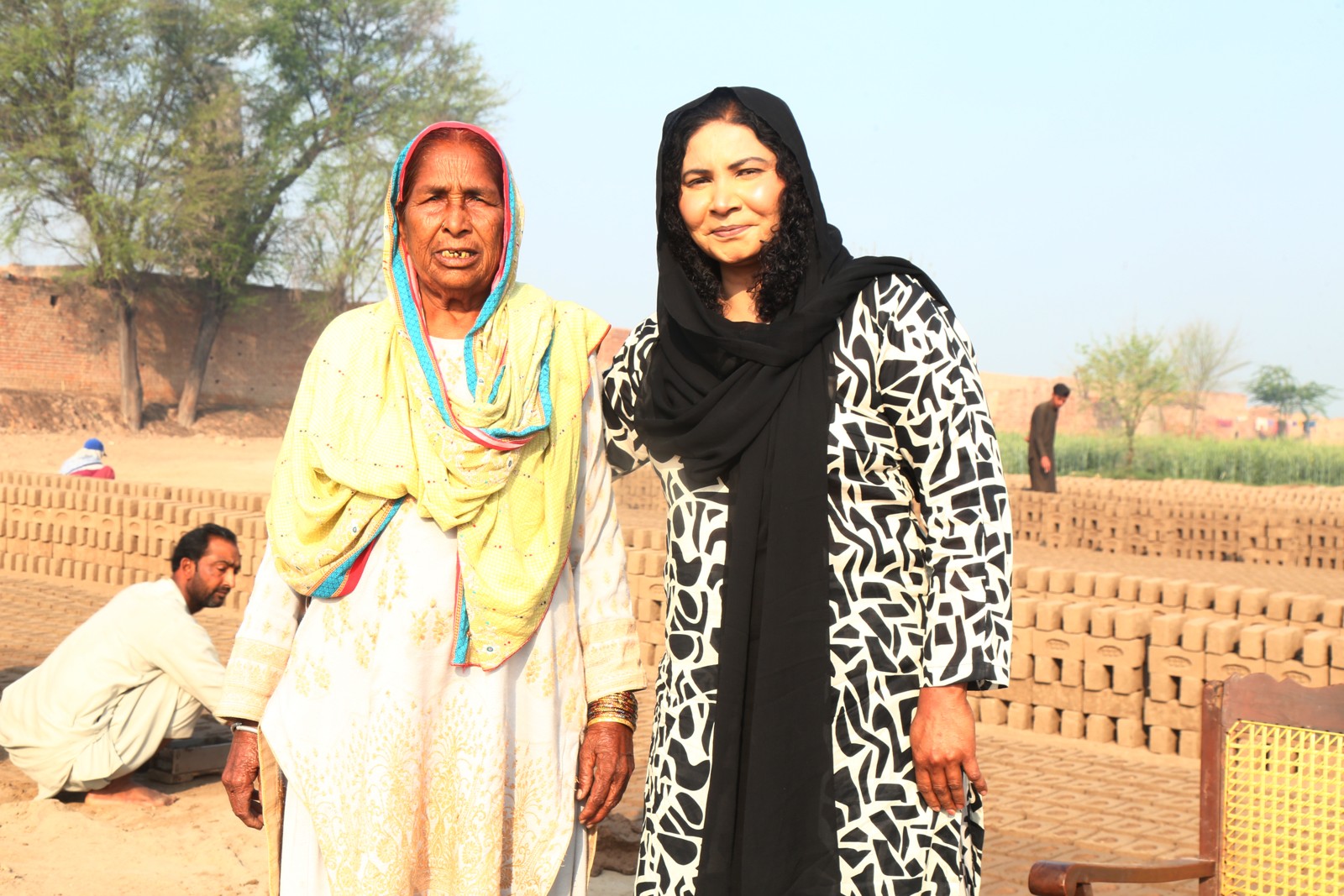 A grandmother from the kiln community with a TLUCF team member