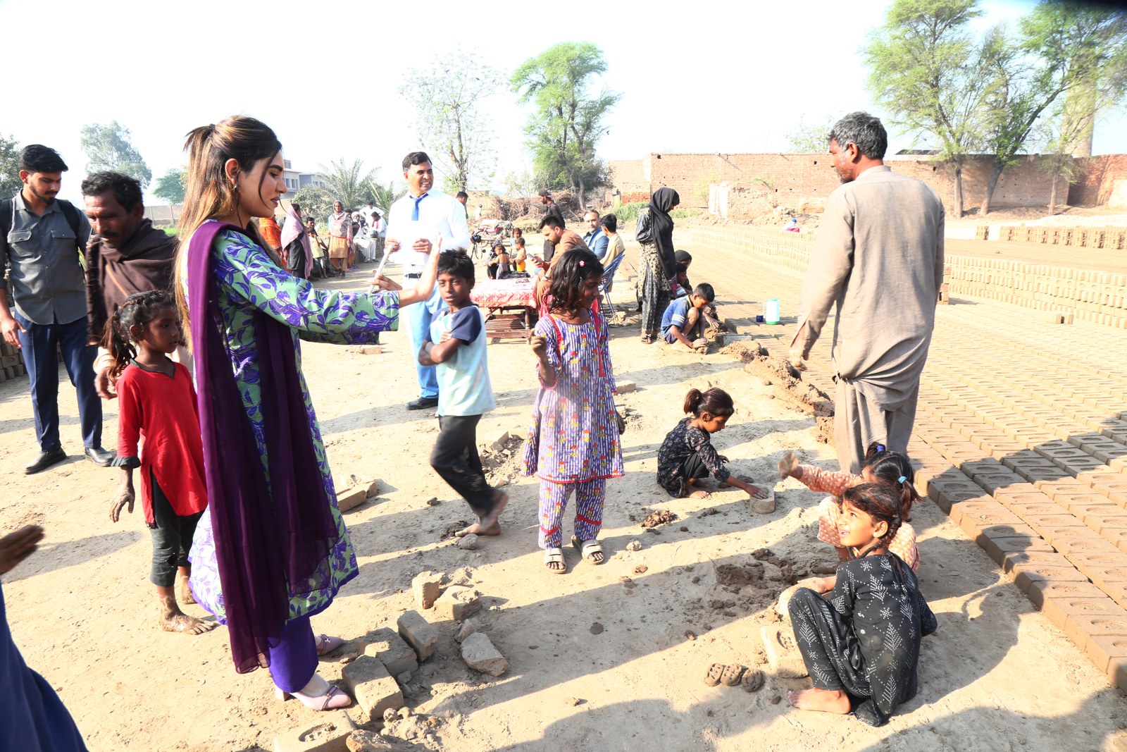 A TLUCF team member spending time with children at the kiln
